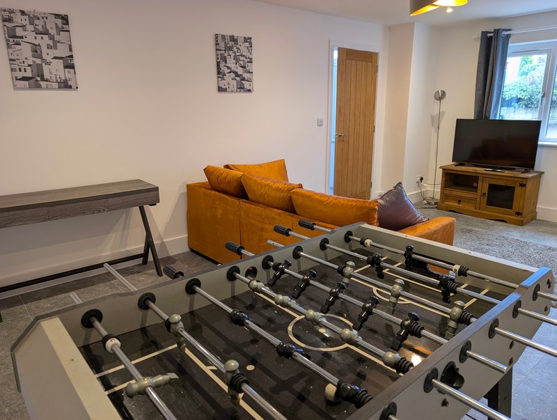 A fun and social space featuring a foosball table, comfortable seating and a Smart TV. It’s a great area for guests to relax and enjoy some friendly competition.