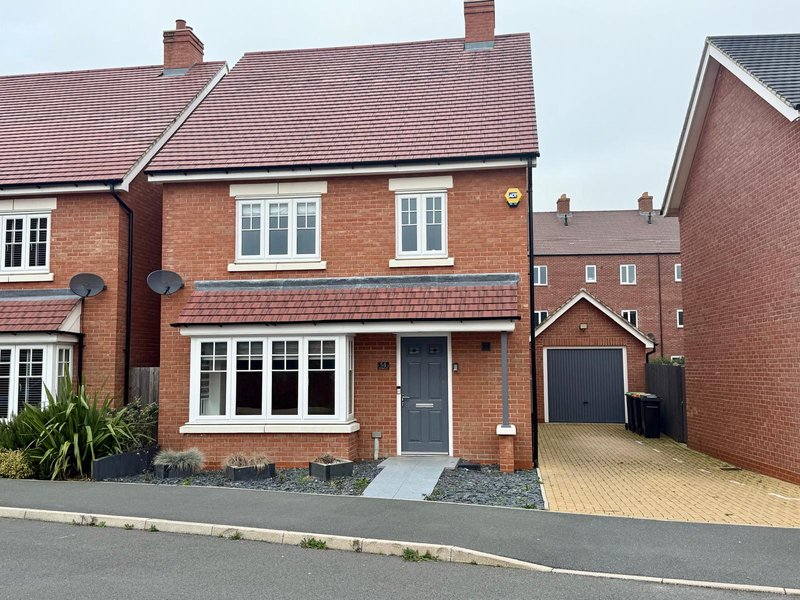 Modern brick detached house with driveway, garage and front garden