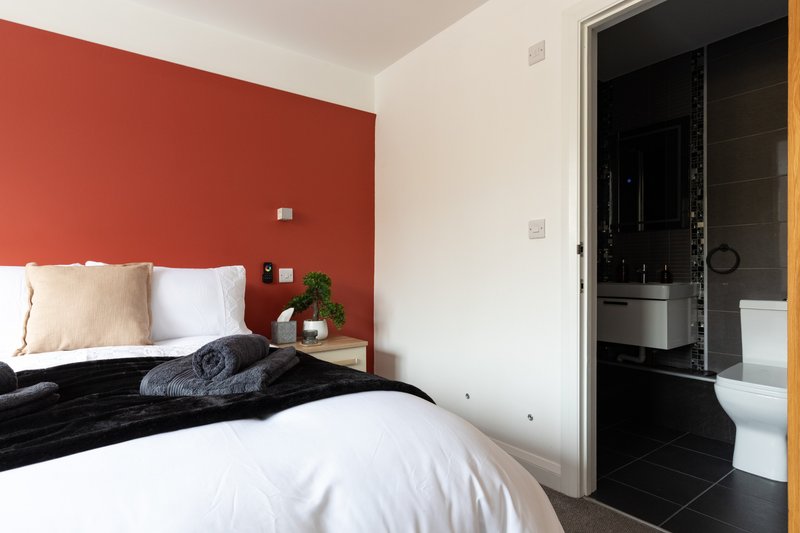 1 double bed and 1 single bed with en-suite shower room. Hanging rail, chest of drawers and bedside drawers. Blackout blinds on window.