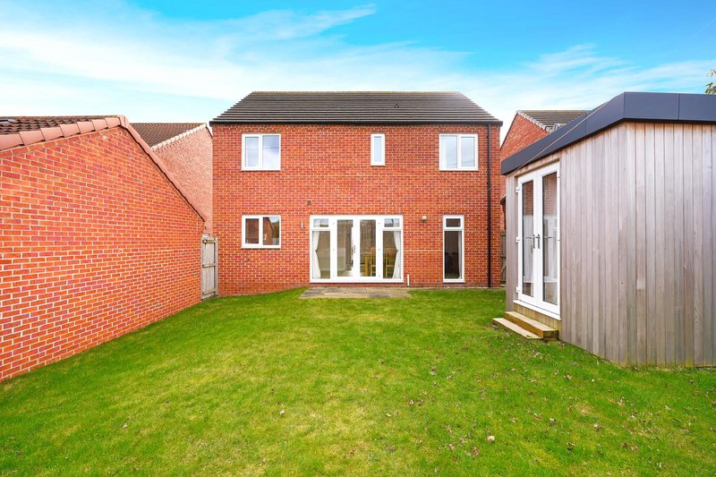Modern brick house with rear garden, lawn, and contemporary extension