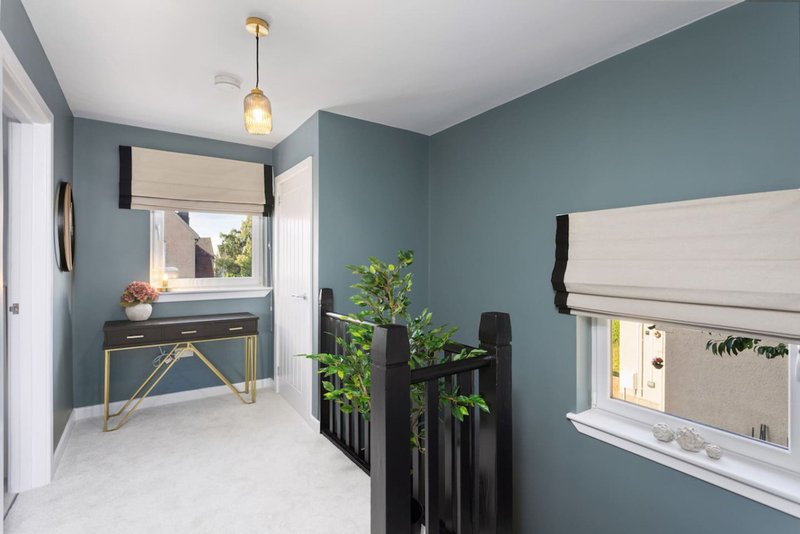 Modern bedroom with teal walls, white marble floor, desk by window and potted plants
