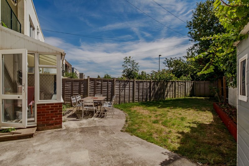 Rear garden with patio area, garden furniture, wooden fence and lawn