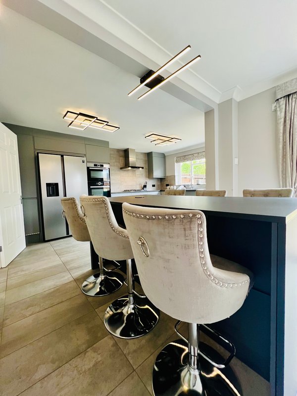 Modern kitchen with island, bar stools, appliances and pendant lighting
