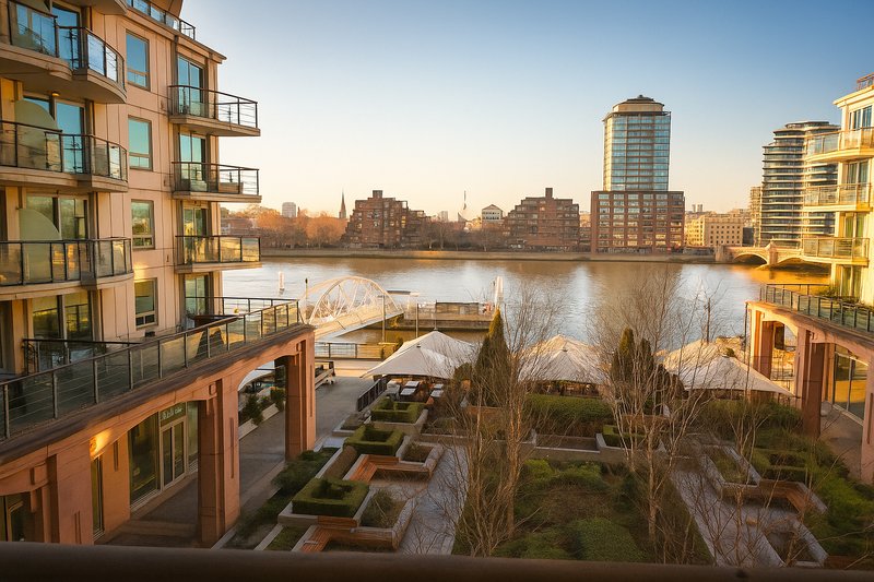 Waterfront apartment complex with river view, modern buildings and landscaped courtyard