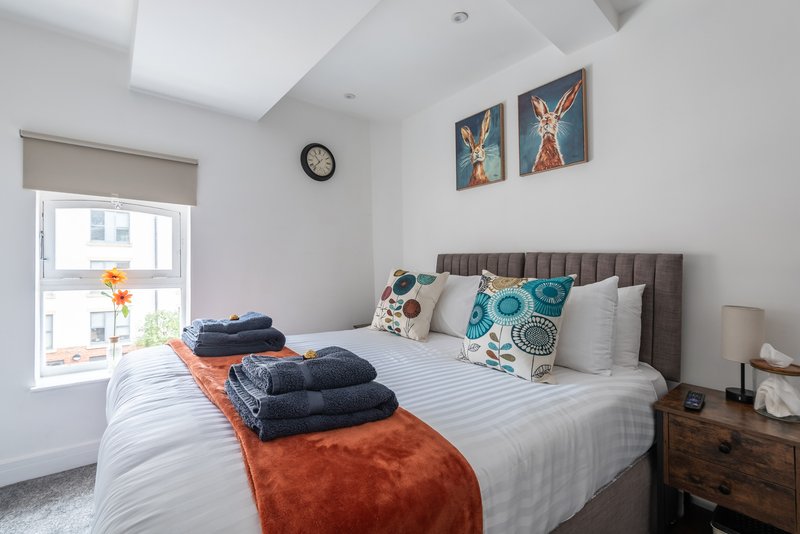 Two flexible bedrooms — king or twin beds, blackout blinds, Smart TVs, premium mattresses