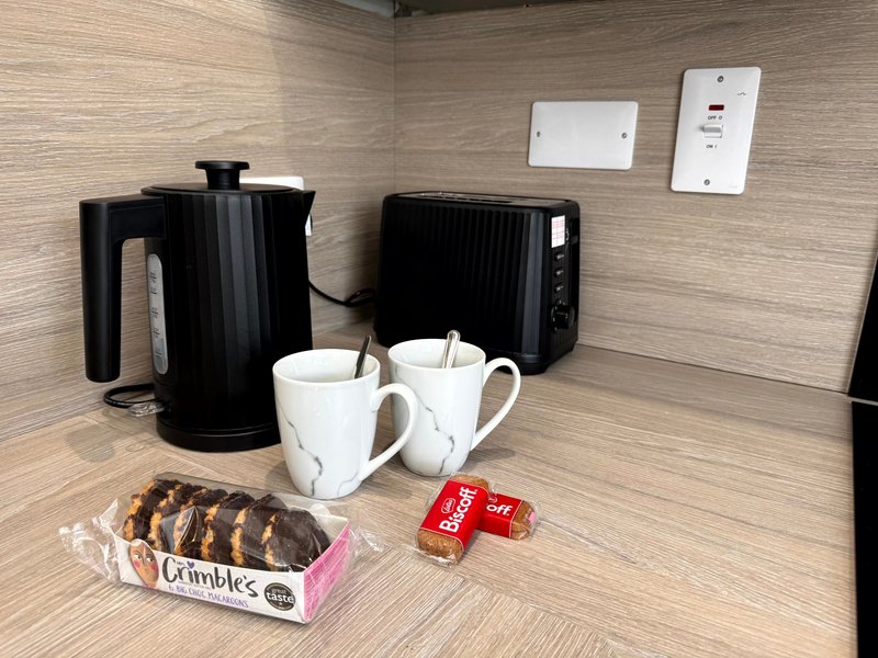 Kitchen counter with kettle, toaster, mugs, biscuits and welcome amenities