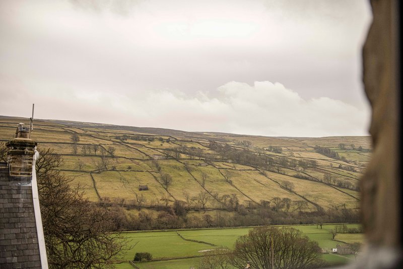 Expansive rural countryside view from property with rolling green fields and distant hills