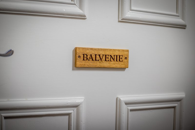 White interior door with decorative wooden nameplate reading 'BAIVENIE' mounted above