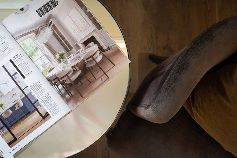 Architectural floor plans and interior design renderings displayed on a round table