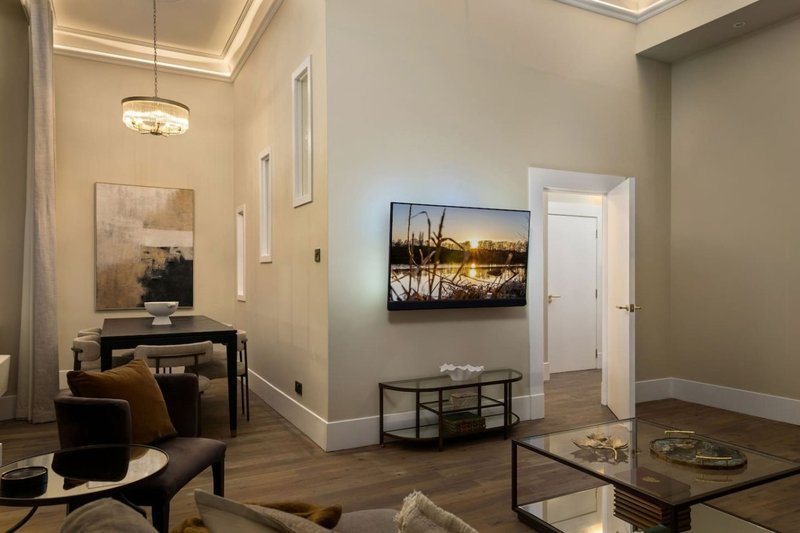 Modern living room with hardwood floors, contemporary furnishings, and wall art