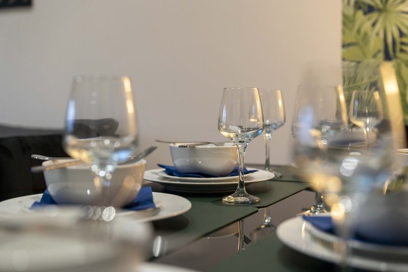 Formal dining table set with plates, glasses, cutlery and table décor