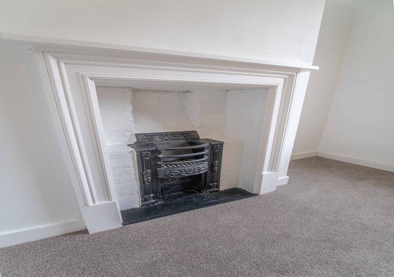 Living room with fireplace, white surround, black marble hearth and mantelpiece