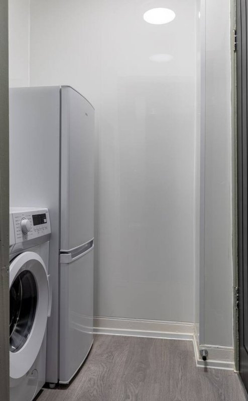 Laundry room with washing machine, refrigerator, and recessed ceiling light