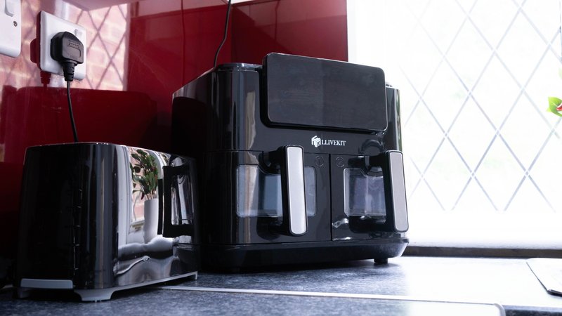 Kitchen counter with black coffee maker, toaster, and small appliances