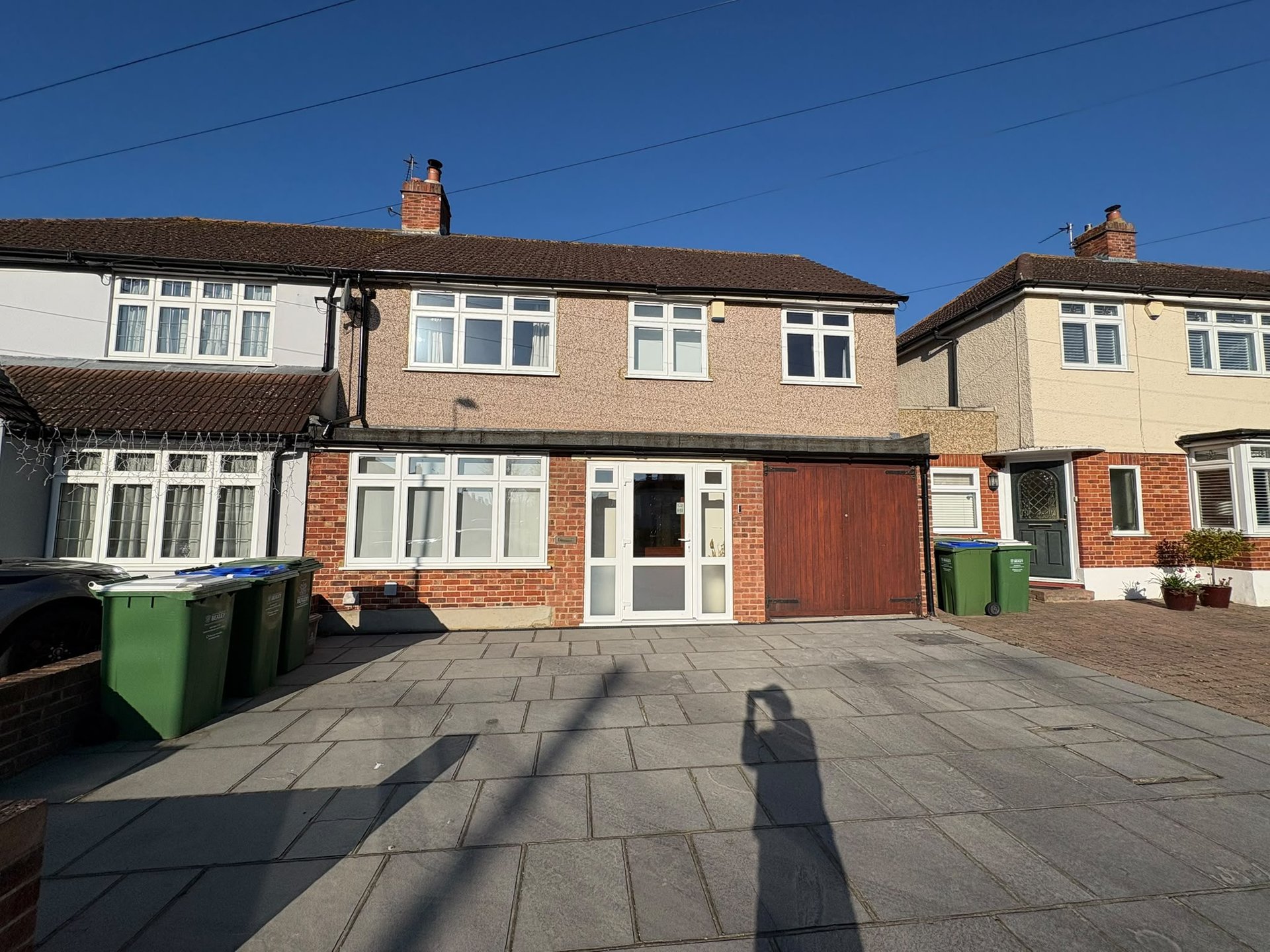 Semi-detached house with brick and rendered facade, driveway, garage and front garden