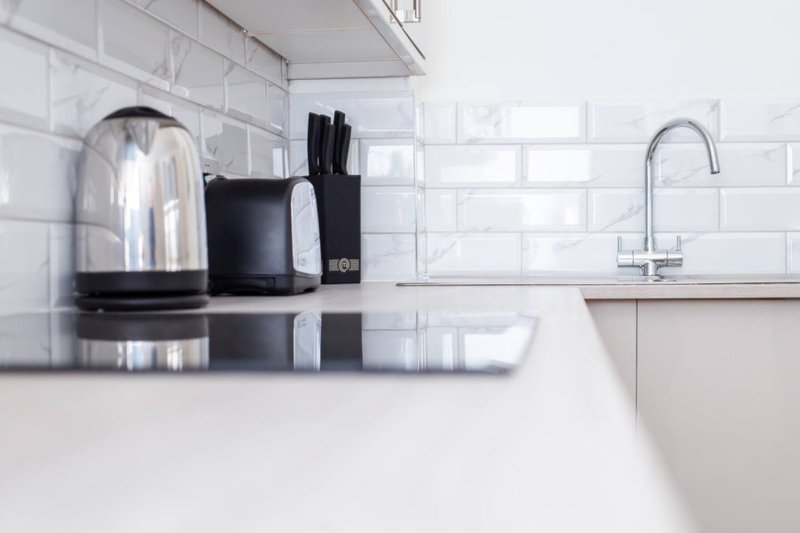 Modern kitchen counter with kettle, toaster, knife block and tap