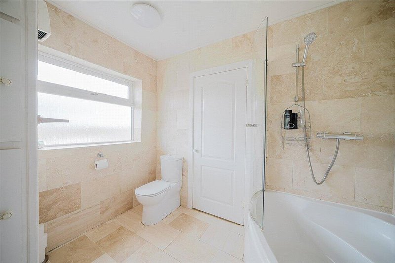 En suite Bathroom with toilet, bathtub, shower and window with natural light