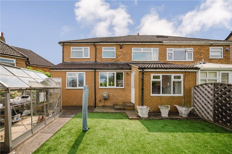 Rear garden with lawn, summer house and garden chairs