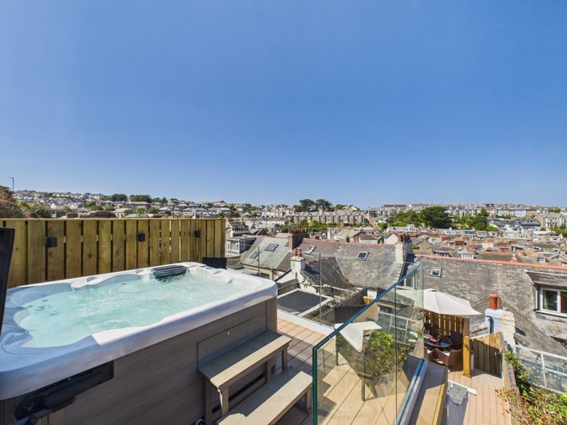 Rooftop terrace with hot tub, wooden decking, and panoramic city views