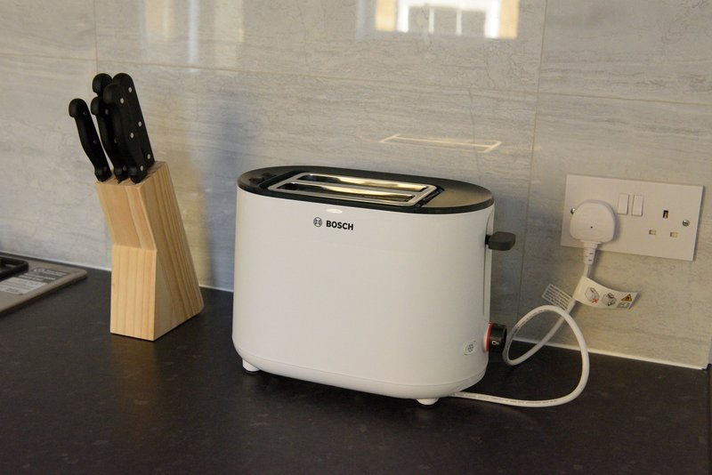 Kitchen countertop with Bosch toaster, knife block, and electrical outlets