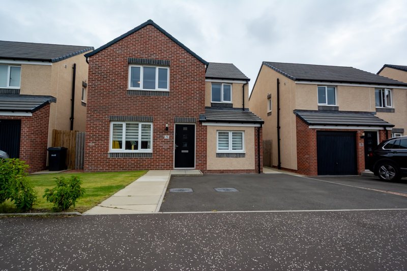 Modern brick detached house with driveway, front garden and neighboring properties