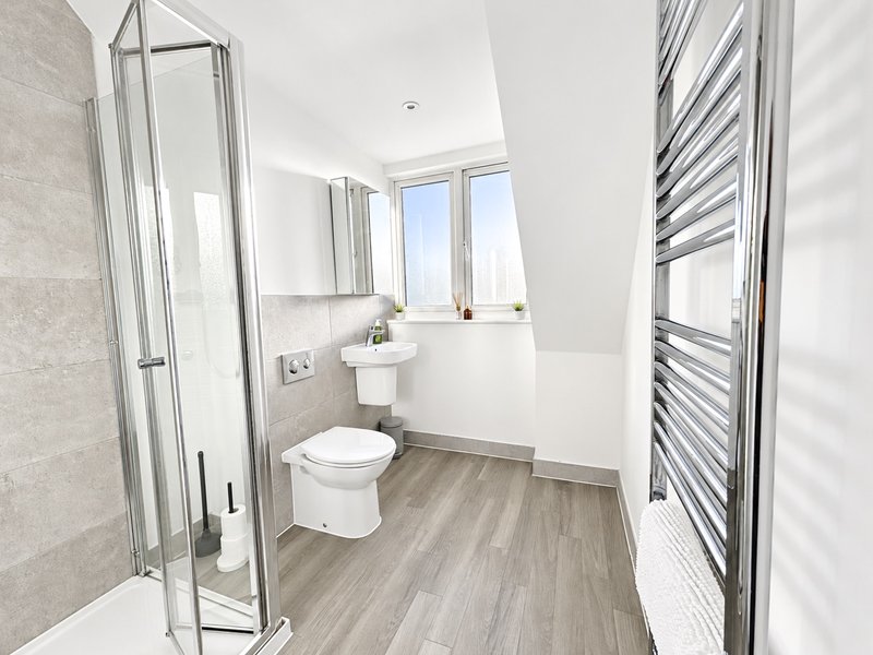 En-suite to bedroom 3 with shower cubicle, toilet, sink, heated towel rail and complimentary toiletries.