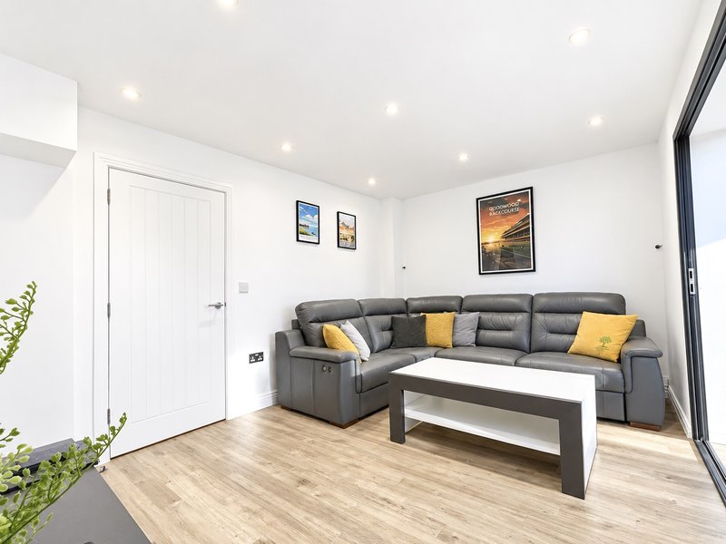 The lounge has a good sized settee along with coffee table and storage units and a smart TV.