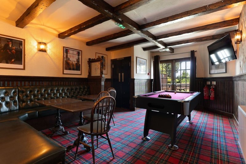 Games room with pool table, dining area, leather seating and tartan carpet flooring