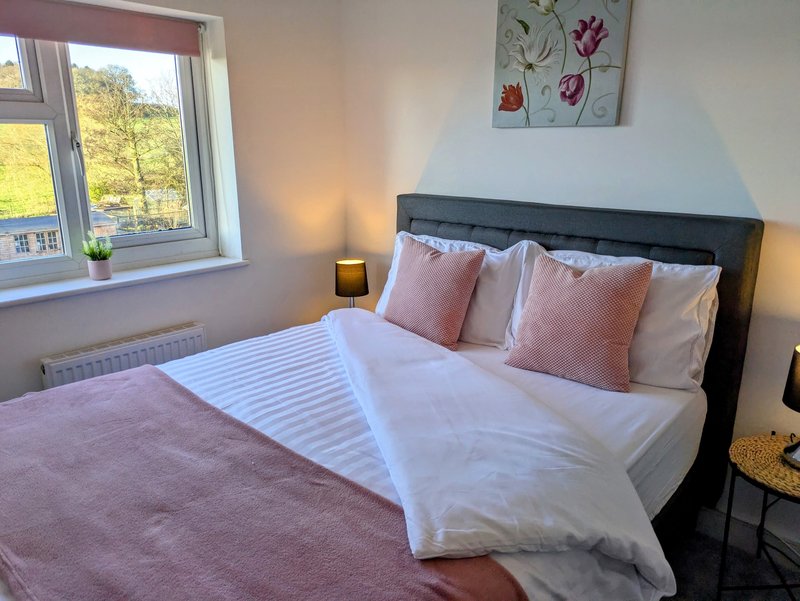 A cosy, well-presented double bedroom with a comfortable bed and a bright outlook over the surrounding countryside. An ideal retreat for contractors and working guests after a long day.