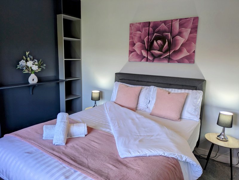 A bright, comfortable double bedroom with a quality bed, fresh linens, bedside tables and lamps. A welcoming space for contractors and working guests to relax and recharge after a busy day.