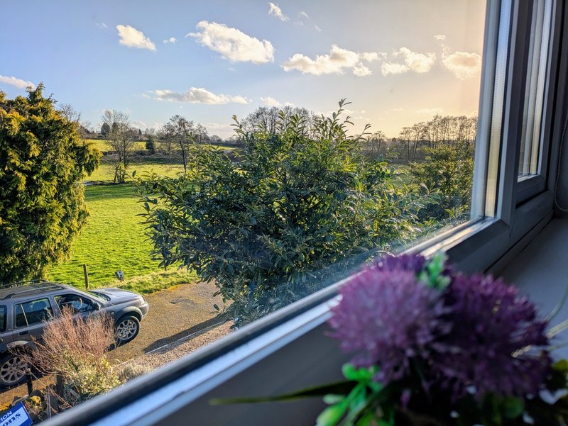 A bright countryside outlook from the property, with lovely open views across the surrounding fields and greenery.