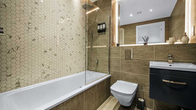 Modern bathroom with bathtub, walk-in shower, toilet, vanity sink and mirror