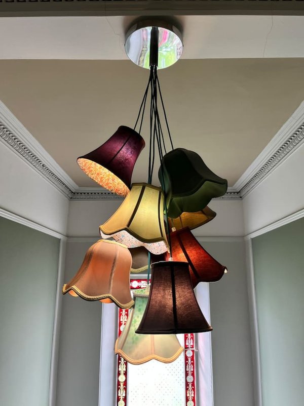 Colorful multi-pendant ceiling light fixture with fabric lampshades in hallway