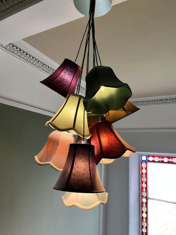 Colorful pendant light fixture with multiple fabric shades hanging from ceiling