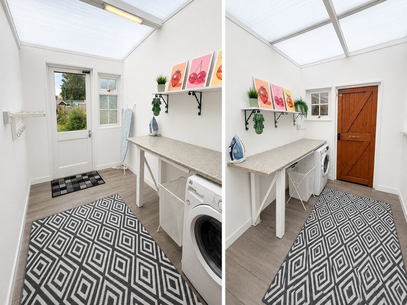 Bright utility room with washing machine, ironing board, shelving and geometric floor tiles