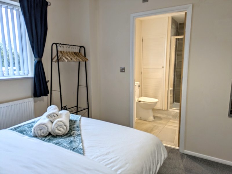 A modern private ensuite shower room conveniently accessed directly from the bedroom. It features a shower, WC and wash basin, providing guests with added privacy and convenience throughout their stay