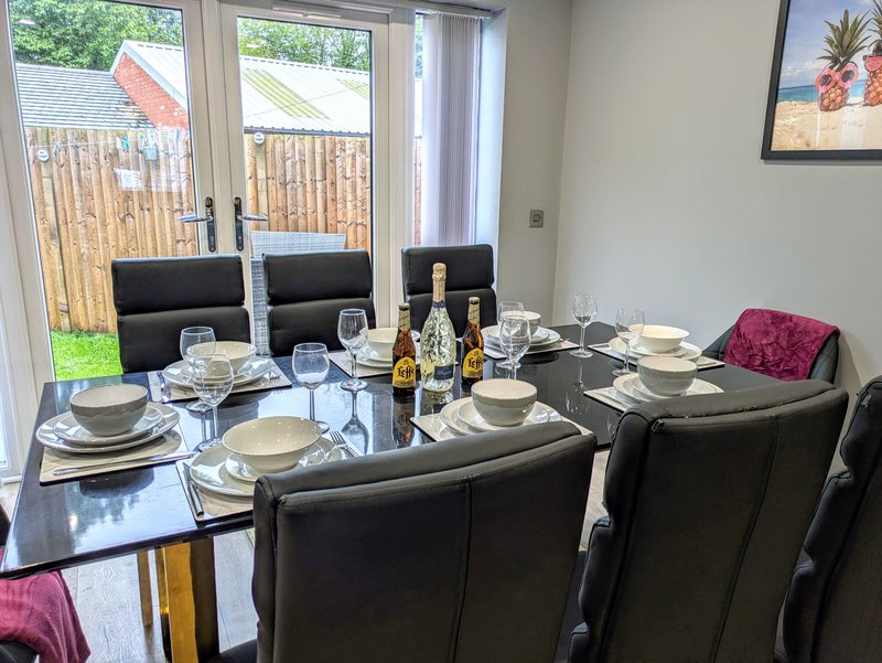 A bright, spacious dining area with a large table seating up to eight guests.
