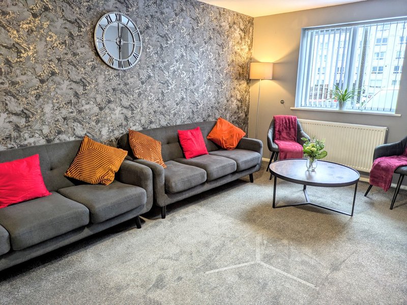 A spacious and comfortable lounge area with plenty of seating, making it ideal to relax together after a busy day.