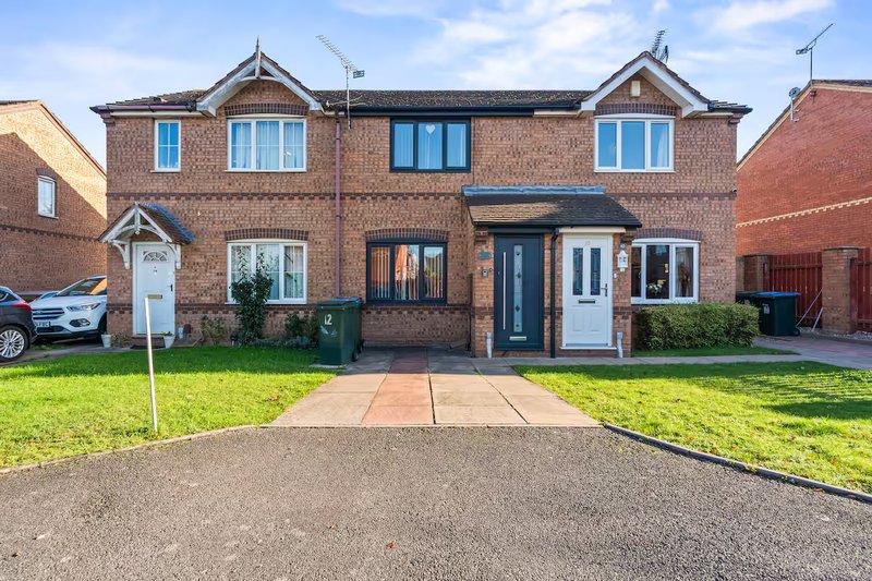 Modern brick semi-detached house with driveway, front garden and multiple windows