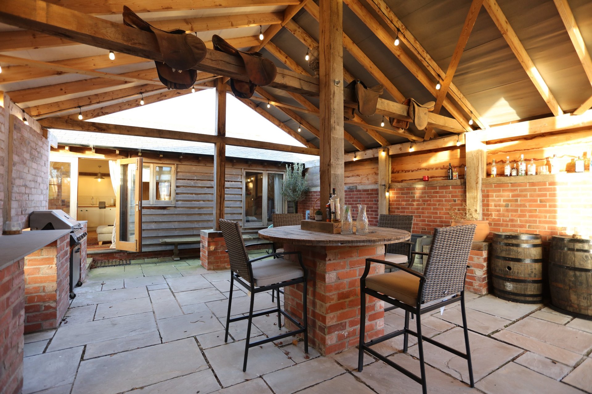Spacious covered outdoor area with a dining table, seating and pizza oven, giving small working groups a great space to relax, eat and unwind after a busy day.
