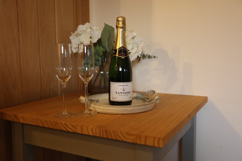 A comfortable dining space for two, perfect for enjoying a relaxed meal after a busy day. A simple, welcoming spot to sit down, unwind and enjoy a drink together.