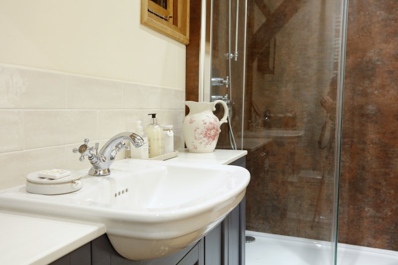 A bright, clean and well-presented bathroom with a modern walk-in shower — ideal for freshening up and relaxing after a long day at work.