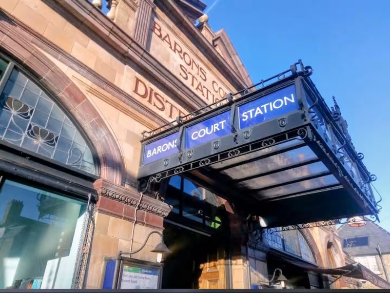 Historic red-brick building facade with blue signage for Court Station and Barclays bank entrance