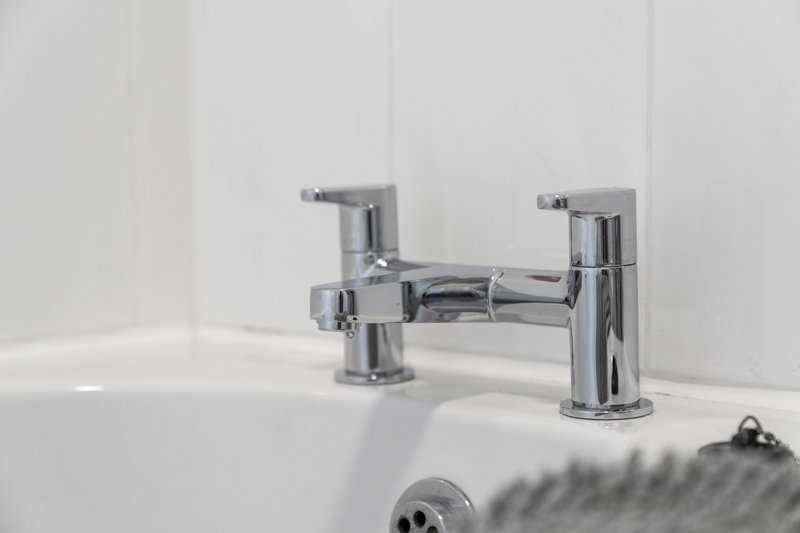 Modern chrome bathroom taps on white sink with minimalist design