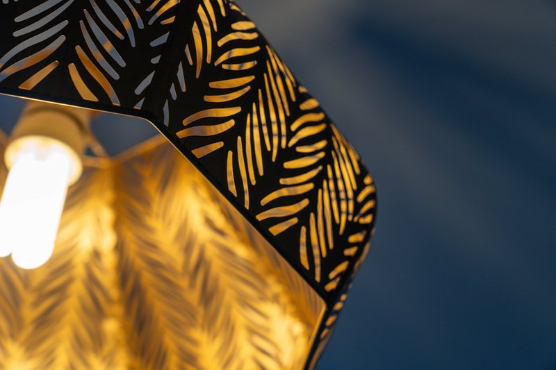 Close-up of decorative yellow and black patterned fabric with outdoor lighting