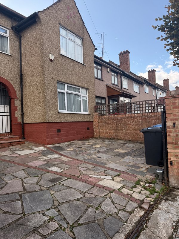 Terraced brick houses with paved courtyard, windows and chimney stacks visible