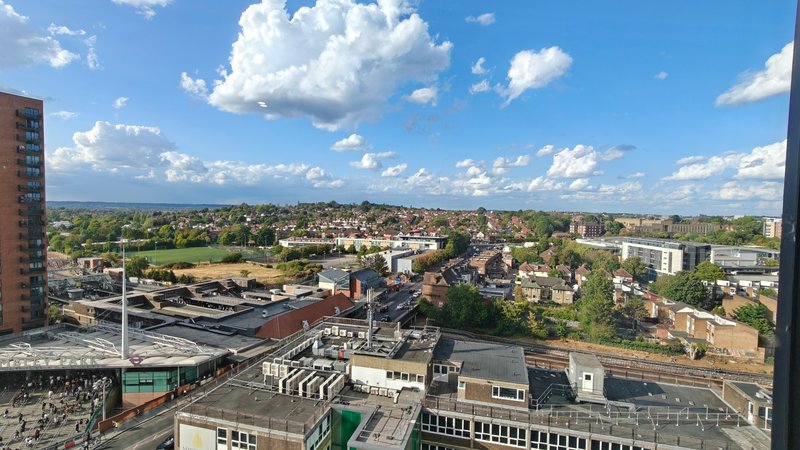 Elevated view of urban townscape with residential buildings, parks and blue sky