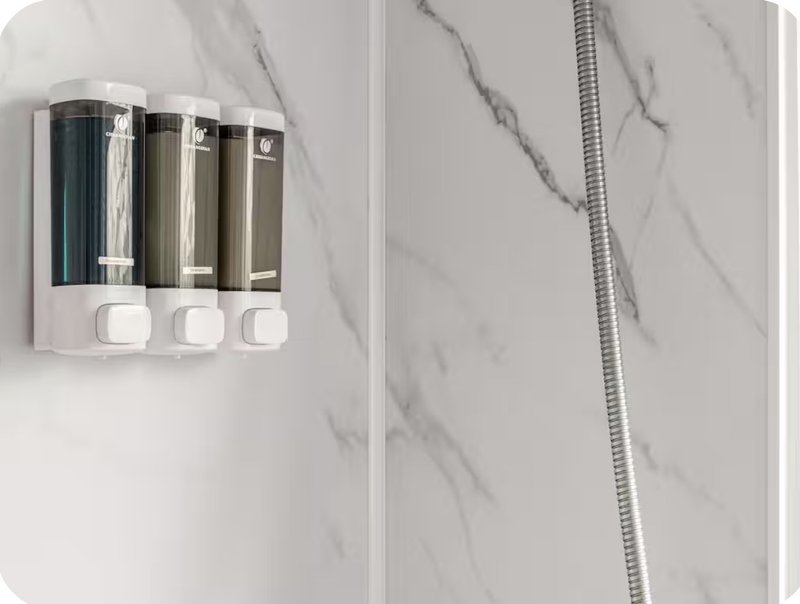 Bathroom wall with marble tile and wall-mounted soap dispenser