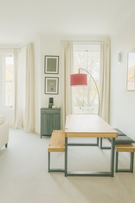 Bright minimalist interior with wooden table, green cabinet, arc lamp and framed wall art