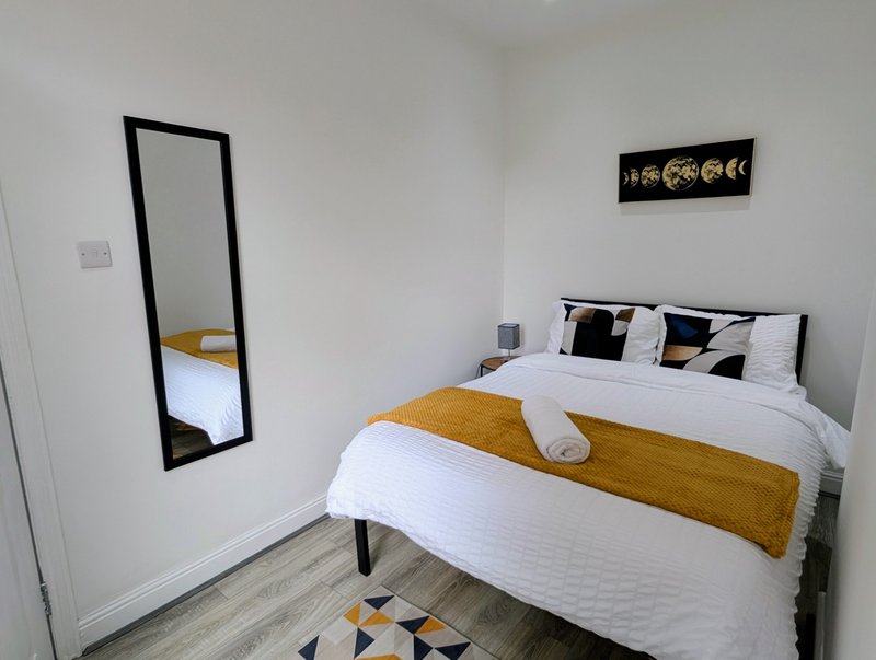 A comfortable and well-presented double bedroom with fresh white bedding, a good-sized bed and a clean, modern feel. The room provides a peaceful space to relax and recharge after a busy day working.